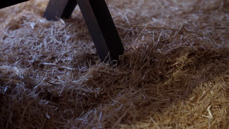 The-leg-of-a-manger-sitting-in-hay-at-night