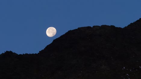 Full-Moon-disappears-behind-mountains---Timelapse