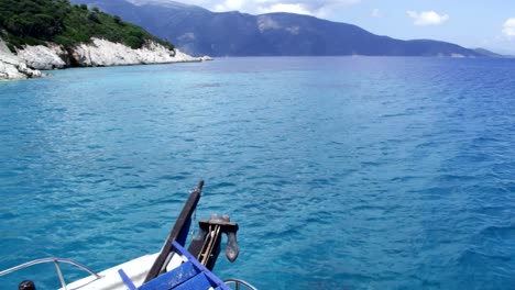 A-boat-sailing-along-the-coast-of-Ithaca-in-Greece