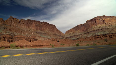 Woman-looking-at-desert-rocks-in-Utah-along-highway-on-vacation