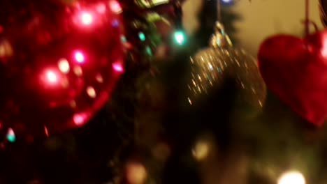 Handheld-shot-searching-through-the-ornaments-of-a-Christmas-tree