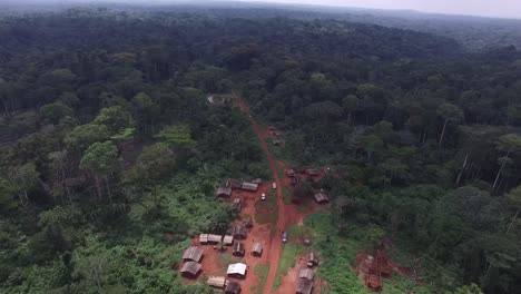 Drone-flying-above-a-village-as-it-appears-buried-in-the-forest