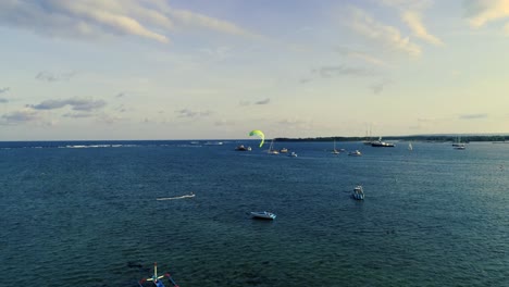 Aerial-view-young-man-kite-surfing-in-tropical-blue-ocean-at-Sanur-Bali