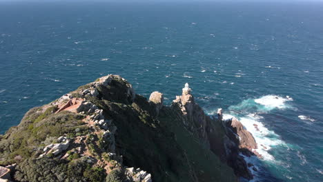 Aerial-Shot-of-People-walking-to-a-Viewpoint-at-Cape-Point,-amazing-scenery