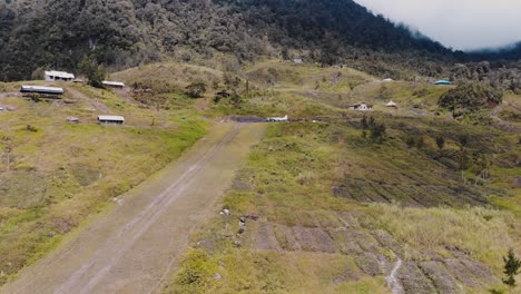 Aerial-footage-of-a-small-aircraft-on-a-mountain-runway-in-the-jungles-of-Papua,-Indonesia