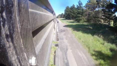 Perspective-view-from-side-of-truck-trailer-travelling-along-roadway