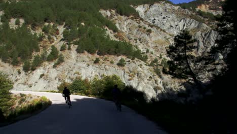 One-cyclist-overtaking-another-in-a-mountain-bike-marathon-in-Tzoumerka-mountains-in-Greece