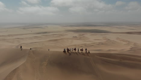 Wide-shot-aerial-rotation-around-large-dune