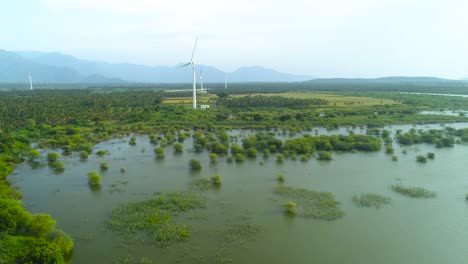 Drone-footage-showing-a-wind-turbines-in-a-beautiful-landscape-with-a-panning-movement