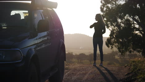 Girls-standing-by-car-at-sunset
