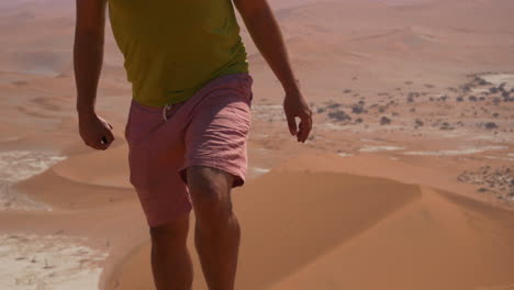 Man-watching-desert-landscape---walking-out-of-shot