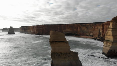 Aerial-panning-right-rotation-views-around-Twelve-Apostles-landscape-over-water