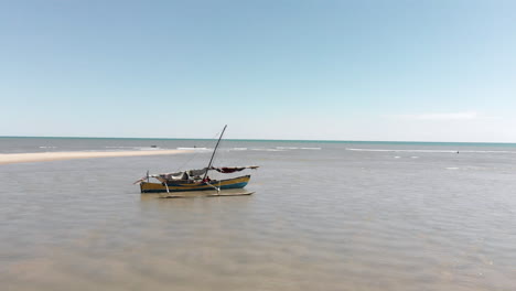 A-Small-Wooden-Boat-is-Beached-and-Abandoned-Along-the-Shallow-Waters-of-the-Coast-of-Africa