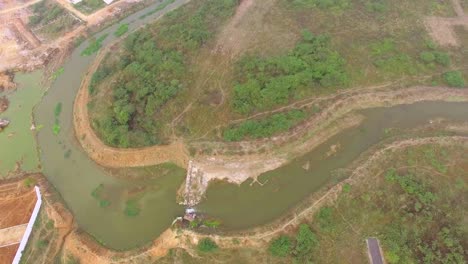 Drone-shot-flying-forward-following-the-tortuous-course-of-a-river-from-above