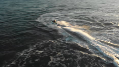 A-Woman-Performs-Tight-Turns-on-a-Jet-Ski-in-an-Open-Ocean-During-a-Beautiful-Sunset
