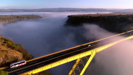 DRONE:-BRIDGE-WITH-MIST-AND-CARS-PASSING-BY