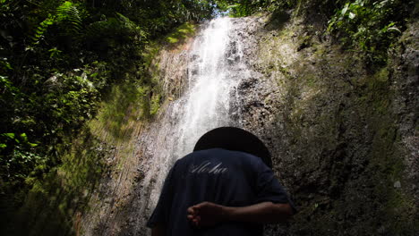 Traditional-man-Looking-up-at-Waterfall-Slow-Motion
