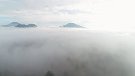 a-blanket-of-mist-covering-ground-flying-towards-mountains-in-mexico