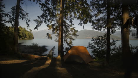 Timelapse-of-Moonlight-Creeping-Across-Camp-Site-and-Tent-on-the-Lake-Front