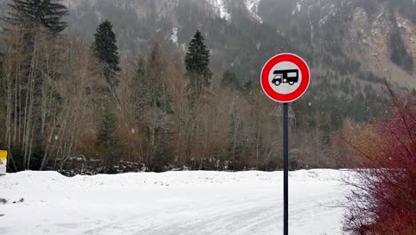 long-view-of-a-camping-car-sign-with-snowy-and-trees-in-the-background