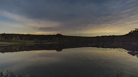 Time-Lapse-of-Stars-and-Clouds-Over-a-Pond-With-Reflections