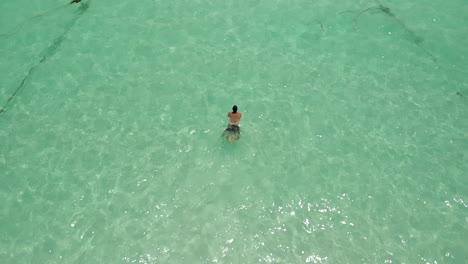 Man-swiming-breaststroke-on-clear-ocean-water-in-slow-motion