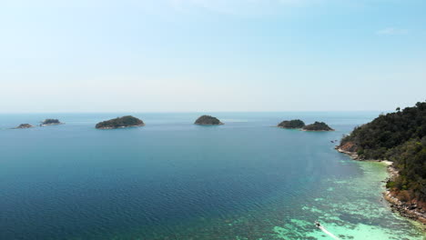 Aerial-view-of-islands-and-a-boats-surrounded-by-clear-waters-in-Thailand