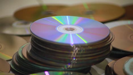 Dolly-shot-of-a-closeup-of-piles-of-old-compact-discs