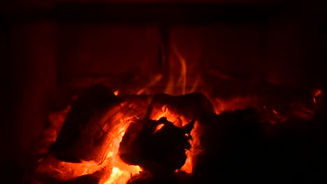 full-screen-view-of-fire-in-a-wood-stove-with-sparks-in-slow-motion