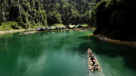 Drone-shot-of-a-bamboo-boat-in-a-lake,-in-Thailand