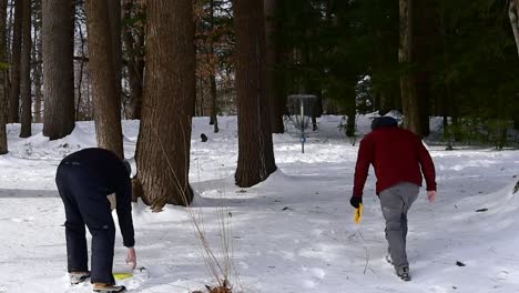 two-men-playing-disc-golf-in-the-snow