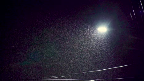 Night-time-street-light-pushing-through-heavy-snow-rain