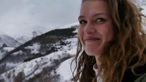 slow-motion-view-of-woman-smiling-at-the-camera-whilst-walking-in-the-mountains