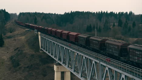 Aerial-view-of-cargo-train-riding-on-the-bridge