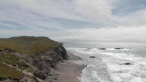 Coastal-cliffs-to-the-ocean,-drone-shot