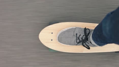 Vertical-close-up-top-POV-shot-of-a-skater-playing-skateboard-or-cruiser-board-on-asphalt