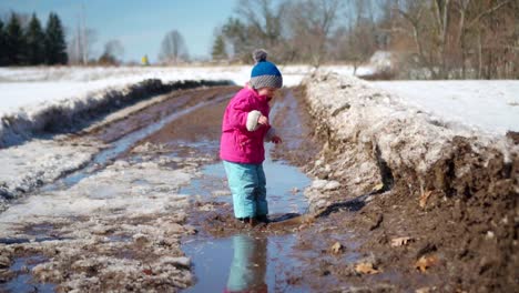 Young-Girl-Jumps-Into-Mud-Puddle-in-Slow-Motion