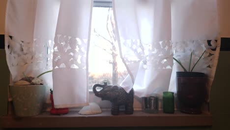 Ein-Mit-Weißen-Vorhängen-Und-Kerzen-Geschmücktes-Fenster-Bei-Sonnenaufgang