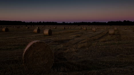 Hay-rolls-during-sunset-time-lapse