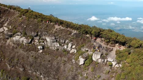 Drone-aerial-shot-push-in-the-top-of-Gede-Pangrango-mountain-with-people-walking-on-the-track