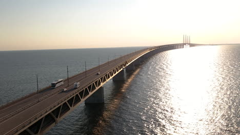 4K-inspire-2-drone-footage-of-the-Öresundsbridge-in-Southern-Sweden-close-up-with-cars-driving-onto-the-bridge-during-sunset