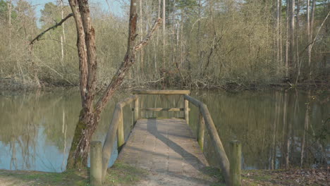 Static-shot-of-a-small-fishing-bridge-on-a-lake-in-France