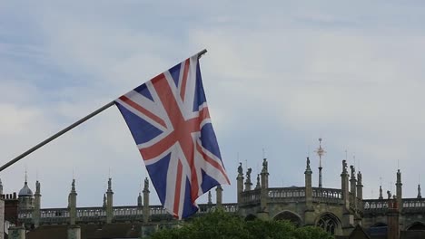 Slow-Motion-British-Flag,-Union-Jack-Flag-Waving-in-the-Wind-in-front-of-a-Church-in-Windsor