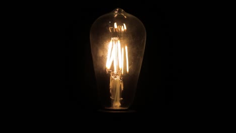 Closeup-of-a-clear-dead-tungsten-light-bulb-turning-on