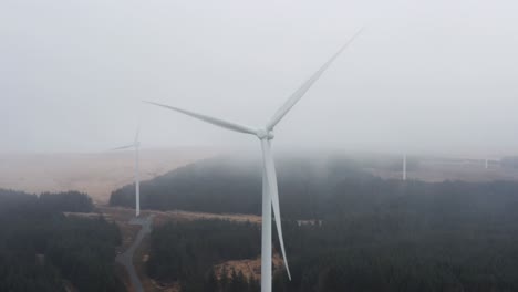 Gloomy-static-aerial-shot-of-wind-farm-turbines-in-heavy-cloud-and-rain-on-the-Rhigos-moutainside-of-the-Welsh-Valleys