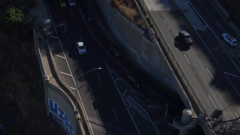 Drone-shot-of-Los-Angeles-Traffic-going-on-a-bridge-and-out-of-a-tunnel