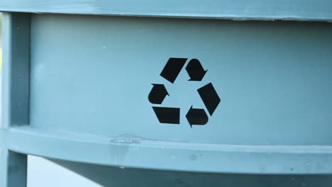 Recycle-Symbol-Imprinted-into-Trash-can-Tracking-Left-Close-Up