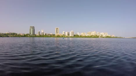 Waves-over-a-lagoon-with-buildings-at-the-horizon