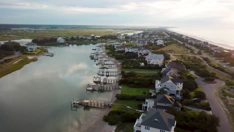 Early-morning-sunrise-drone-pan-to-the-left-flyover-of-figure-eight-island-inner-harbor-from-beach-in-Wilmington-North-Carolina
