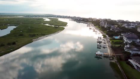 Early-morning-sunrise-drone-one-hundred-and-eighty-degree-pan-from-left-to-right-flyover-of-figure-eight-island-inner-harbor-in-Wilmington-North-Carolina